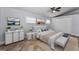 Bright bedroom features neutral decor, a ceiling fan, a double bed with ample storage, and natural light at 4849 Floramar Ter, New Port Richey, FL 34652