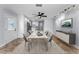 Bright dining room featuring modern decor, stylish furnishings, and seamless flow to the kitchen at 4849 Floramar Ter, New Port Richey, FL 34652