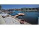 Waterfront property featuring a private dock with boat access, complemented by views of nearby condos at 4849 Floramar Ter, New Port Richey, FL 34652