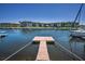 Private boat dock extending into the waterfront, with scenic views of waterfront condos in the background at 4849 Floramar Ter, New Port Richey, FL 34652