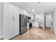 Modern kitchen featuring stainless steel appliances, white cabinets, and tile flooring at 4849 Floramar Ter, New Port Richey, FL 34652