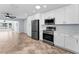 Modern kitchen featuring stainless steel appliances, white cabinets, and an open layout at 4849 Floramar Ter, New Port Richey, FL 34652
