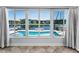 Bright living room with large windows showcasing scenic waterfront views and serene natural light at 4849 Floramar Ter, New Port Richey, FL 34652