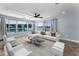 Living room features large windows with views of the water and boats at 4849 Floramar Ter, New Port Richey, FL 34652