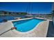 Beautiful pool with marina view, featuring yachts, and waterfront condos against a clear blue sky backdrop at 4849 Floramar Ter, New Port Richey, FL 34652