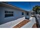 Side exterior of home with access door and decorative rock feature at 4849 Floramar Ter, New Port Richey, FL 34652