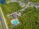 Overhead shot of community pool area featuring a unique pool design, outdoor seating, and beautifully landscaped surroundings at 4906 Los Robles Ct, Palmetto, FL 34221