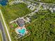 Aerial view of the community pool and clubhouse, surrounded by lush greenery and well-maintained landscaping at 4906 Los Robles Ct, Palmetto, FL 34221
