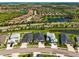 Aerial view of a neighborhood with homes and ponds surrounded by tropical landscapes at 4906 Los Robles Ct, Palmetto, FL 34221