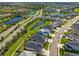 Aerial view of a neighborhood with ponds, well-maintained landscaping, and varied home styles at 4906 Los Robles Ct, Palmetto, FL 34221