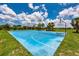 Outdoor blue basketball court with palm trees and benches in a well-maintained community park on a sunny day at 4906 Los Robles Ct, Palmetto, FL 34221