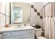 Bright bathroom featuring a vanity, sink, and decorated toilet at 4906 Los Robles Ct, Palmetto, FL 34221
