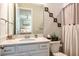 Bathroom with white vanity, mirror and a shower with curtains at 4906 Los Robles Ct, Palmetto, FL 34221