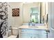 Clean bathroom featuring a modern vanity, stylish mirror, and decorative shower curtain at 4906 Los Robles Ct, Palmetto, FL 34221