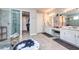 Bright bathroom with double vanity, walk-in shower, and linen closet at 4906 Los Robles Ct, Palmetto, FL 34221