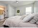 Bright bedroom with a neutral palette, features a ceiling fan, walk-in closet, and natural light from a window at 4906 Los Robles Ct, Palmetto, FL 34221