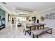 Bright and airy dining area with a custom table, an elegant ceiling, and sliding glass doors to the backyard at 4906 Los Robles Ct, Palmetto, FL 34221