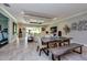 Bright dining area with a large wooden table, tile floors, and an open layout to the living space at 4906 Los Robles Ct, Palmetto, FL 34221