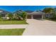 Charming home with lush landscaping, a well-manicured lawn and a two-car garage at 4906 Los Robles Ct, Palmetto, FL 34221
