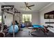 Well-equipped home gym with weightlifting equipment, exercise bike, and rubber flooring at 4906 Los Robles Ct, Palmetto, FL 34221