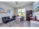 Home office with dark leather sofa and a modern desk, featuring a large window for natural light at 4906 Los Robles Ct, Palmetto, FL 34221