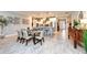 Open-concept kitchen with a wooden dining table, an elegant design, and easy access to the entryway at 4906 Los Robles Ct, Palmetto, FL 34221