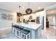 Modern kitchen with a large island, granite countertops, stainless steel appliances, and pendant lighting at 4906 Los Robles Ct, Palmetto, FL 34221