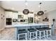 Gourmet kitchen with a large island, stainless steel appliances, custom cabinetry, and modern lighting fixtures at 4906 Los Robles Ct, Palmetto, FL 34221