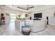 Open-concept living room with a plush sofa, stylish décor, and seamless flow to the outdoor area at 4906 Los Robles Ct, Palmetto, FL 34221