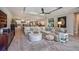 Open-concept living room, showcasing a large sectional sofa, neutral color palette, and stylish decor at 4906 Los Robles Ct, Palmetto, FL 34221