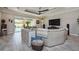 Comfortable living room with a large sofa, tray ceiling, access to backyard, and neutral decor at 4906 Los Robles Ct, Palmetto, FL 34221