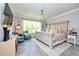 Bright main bedroom with stylish furniture, TV, ceiling fan, and large windows at 4906 Los Robles Ct, Palmetto, FL 34221
