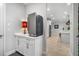 Pantry with a countertop and storage, with stainless steel refrigerator and hardwood floors at 4906 Los Robles Ct, Palmetto, FL 34221