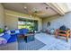 Relaxing covered patio with cozy seating, outdoor grill, and a serene outdoor ambiance at 4906 Los Robles Ct, Palmetto, FL 34221