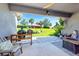 Inviting covered patio with outdoor grill, comfortable seating, and tranquil backyard views at 4906 Los Robles Ct, Palmetto, FL 34221