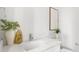 Bright bathroom featuring a white vanity with marble countertop, modern fixtures, and stylish decor at 50 64Th S St, St Petersburg, FL 33707