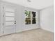 Bright, carpeted bedroom with a modern door and large window offering pleasant outdoor views at 50 64Th S St, St Petersburg, FL 33707