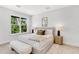 Cozy bedroom featuring a large window, neutral colors, and a comfortable king-size bed with stylish accents at 50 64Th S St, St Petersburg, FL 33707