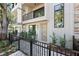 Close-up of a modern townhome entrance with a wood door, sleek lines, and a landscaped front garden at 50 64Th S St, St Petersburg, FL 33707