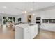 Bright, modern kitchen open to the living area features a large island, white cabinets, and stainless appliances at 50 64Th S St, St Petersburg, FL 33707