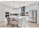 Sleek, modern kitchen featuring white cabinets, stainless steel appliances, and stylish pendant lighting at 50 64Th S St, St Petersburg, FL 33707