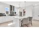 Modern kitchen with white cabinets, center island, stainless steel appliances, and designer lighting at 50 64Th S St, St Petersburg, FL 33707