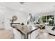 Open concept living and dining area with modern furniture, light wood floors, and lots of natural light at 50 64Th S St, St Petersburg, FL 33707