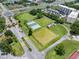 Community aerial view featuring tennis and other recreation courts, as well as nearby highways and buildings at 511 Foxglove Cir # B, Sun City Center, FL 33573