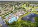 Stunning aerial view showcasing the community clubhouse, pool, tennis courts, golf course, and beautiful landscaping at 511 Foxglove Cir # B, Sun City Center, FL 33573