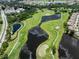 Beautiful aerial view of the golf course and surrounding community with scenic ponds and manicured green spaces at 511 Foxglove Cir # B, Sun City Center, FL 33573