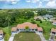 An aerial view of a charming single-Gathering home with well-manicured front yard and mature trees at 511 Foxglove Cir # B, Sun City Center, FL 33573