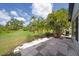 Tiled backyard patio overlooks lush greenery and tropical landscaping at 511 Foxglove Cir # B, Sun City Center, FL 33573