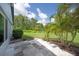 Tiled backyard patio overlooks lush greenery and tropical landscaping at 511 Foxglove Cir # B, Sun City Center, FL 33573