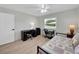 Comfortable bedroom featuring a desk area and a cozy bed with natural light from the window at 511 Foxglove Cir # B, Sun City Center, FL 33573